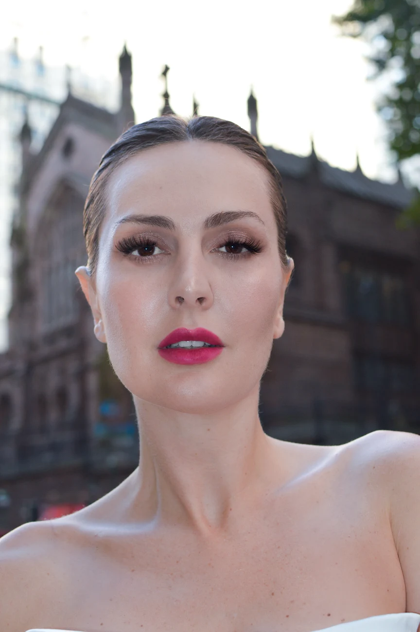 Bridal portrait with a defined lip color and swept-back hair.